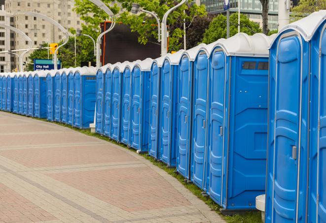 a line of portable restrooms at a sporting event, providing athletes and spectators with clean and accessible facilities in Edwardsville